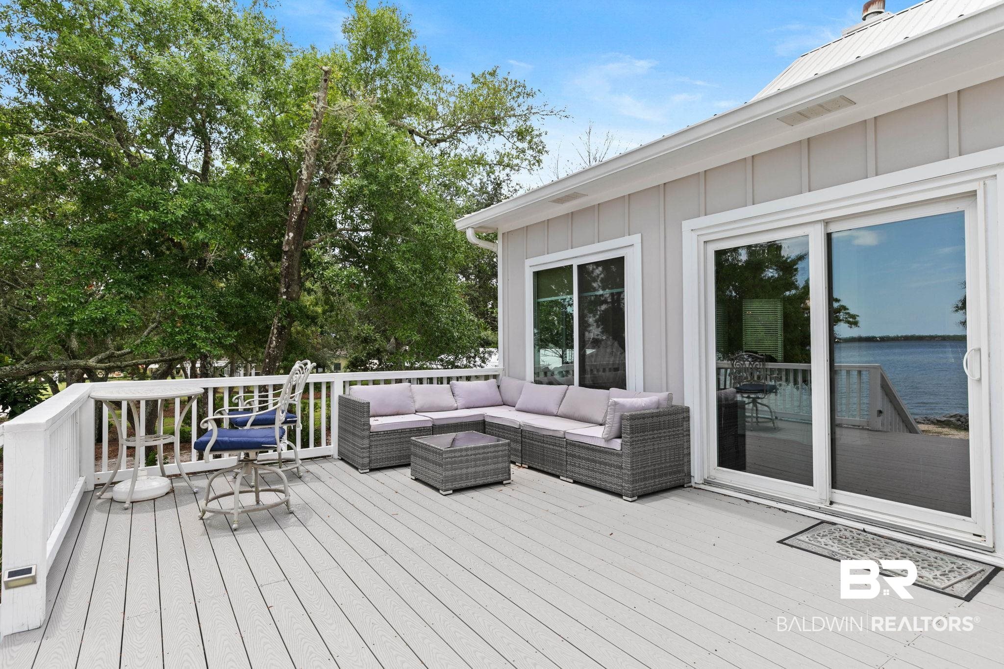 6802 Shore Drive Elberta, AL 36530 - Photo 10 of 34 Spacious outdoor deck featuring gray wood-finish decking, white railings, and direct water frontage