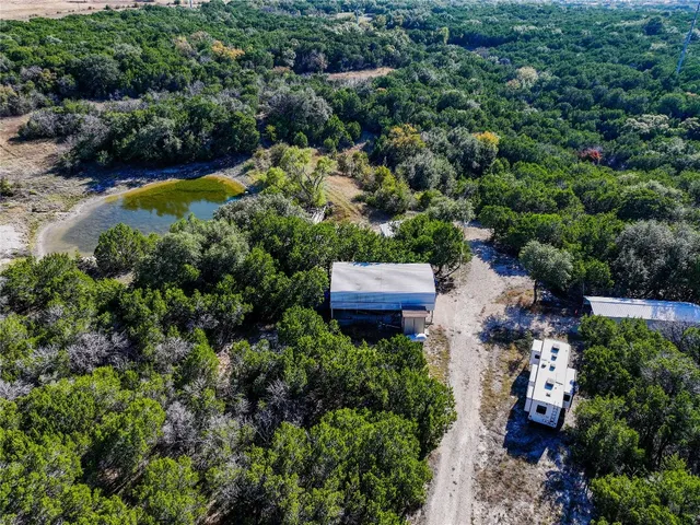 an aerial view of a house with a yard