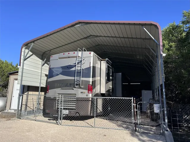 a backyard of a house with table and chairs