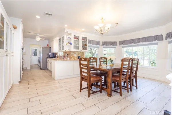 a view of a dining room with furniture and chandelier