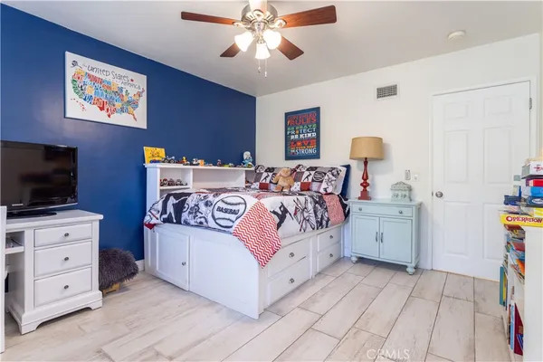 a bedroom with a bed and a flat screen tv