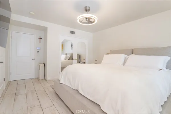 a bedroom with a bed and a chandelier