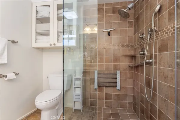 a bathroom with a toilet and a shower