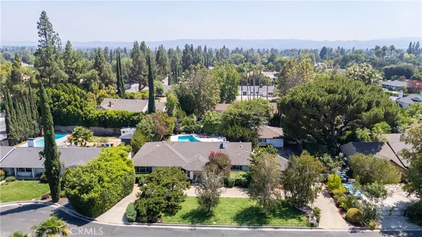 an aerial view of house with yard swimming pool and outdoor seating