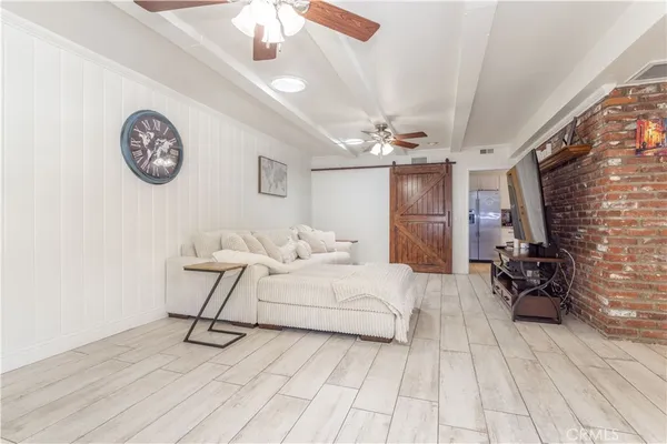 a spacious bedroom with a bed and a chandelier