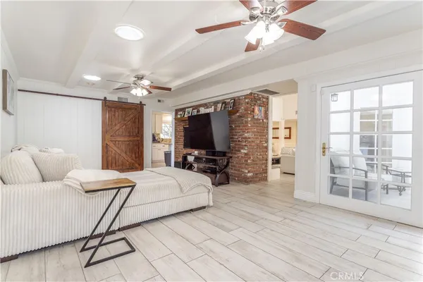 a living room with a bed furniture and a flat screen tv