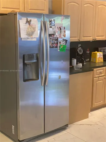 a kitchen with granite countertop a sink a counter top space appliances and cabinets