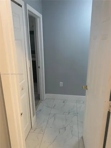 a spacious bathroom with a granite countertop sink and a mirror