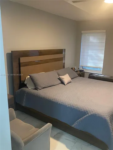 a bedroom with a bed and a couch