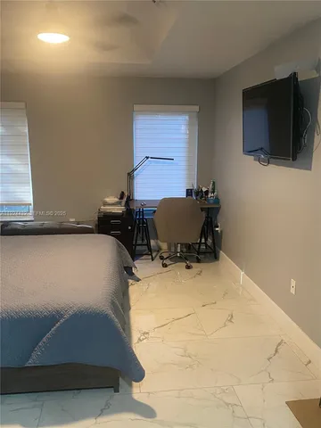 a room with a bed and window