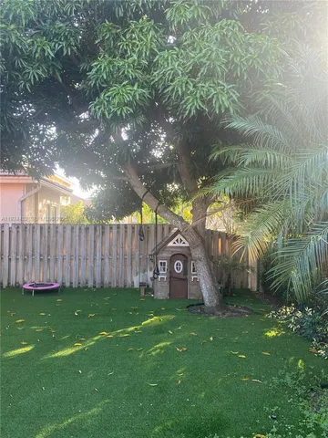 a backyard of a house with lots of green space and garden