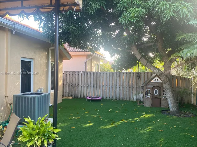 a view of a house with backyard porch and garden