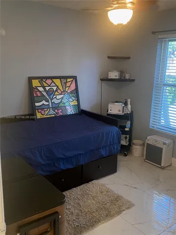 a bedroom with a bed and window