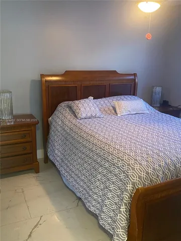 a bedroom with a bed and chair