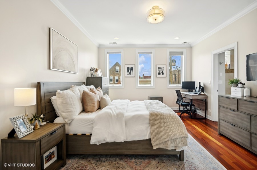 1411 West Chicago Avenue, Unit 3 Chicago, IL 60642 - Photo 11 of 17 a bedroom with a bed and wooden floor