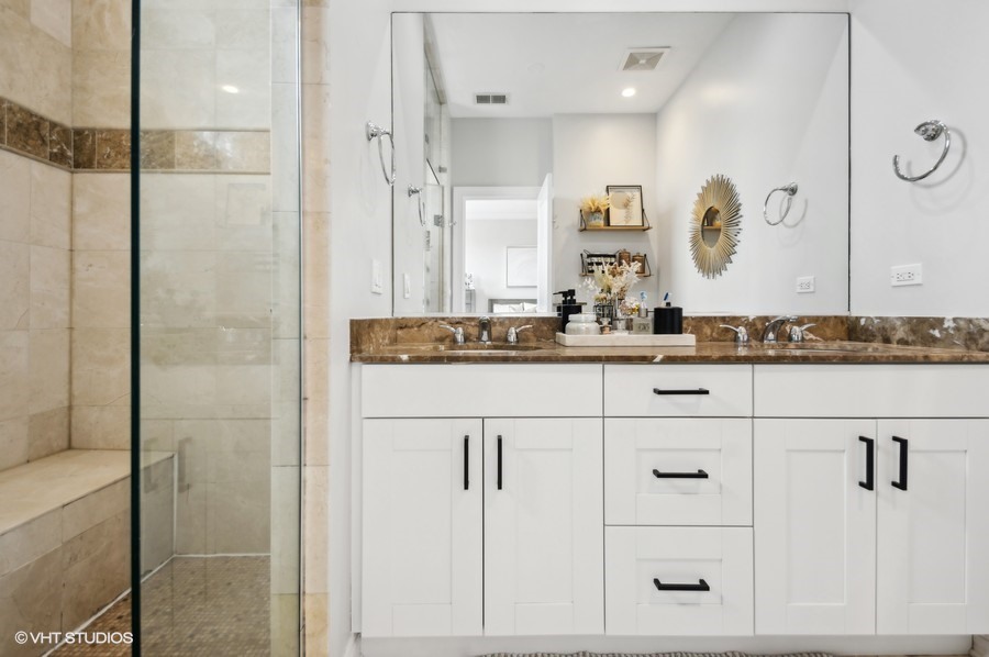 1411 West Chicago Avenue, Unit 3 Chicago, IL 60642 - Photo 12 of 17 a bathroom with a double vanity sink and mirror