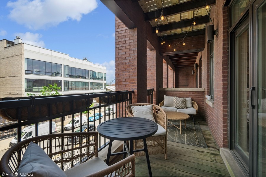 1411 West Chicago Avenue, Unit 3 Chicago, IL 60642 - Photo 8 of 17 a view of a chairs and table in the balcony