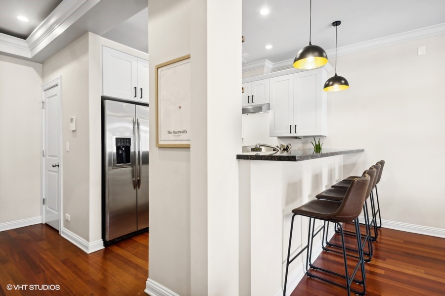 1411 West Chicago Avenue, Unit 3 Chicago, IL 60642 - Photo 9 of 17 a kitchen with dining table and a refrigerator