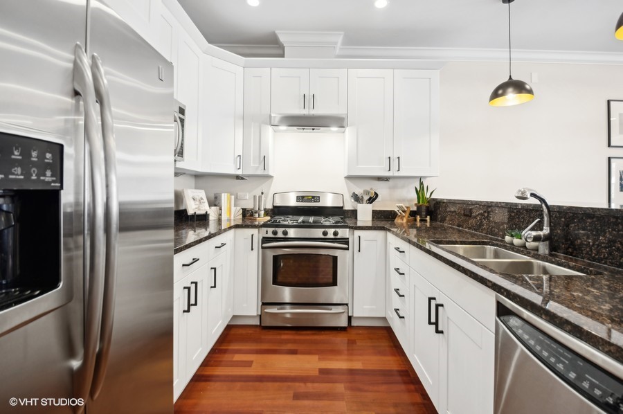 1411 West Chicago Avenue, Unit 3 Chicago, IL 60642 - Photo 10 of 17 a kitchen with granite countertop a stove a sink and a refrigerator