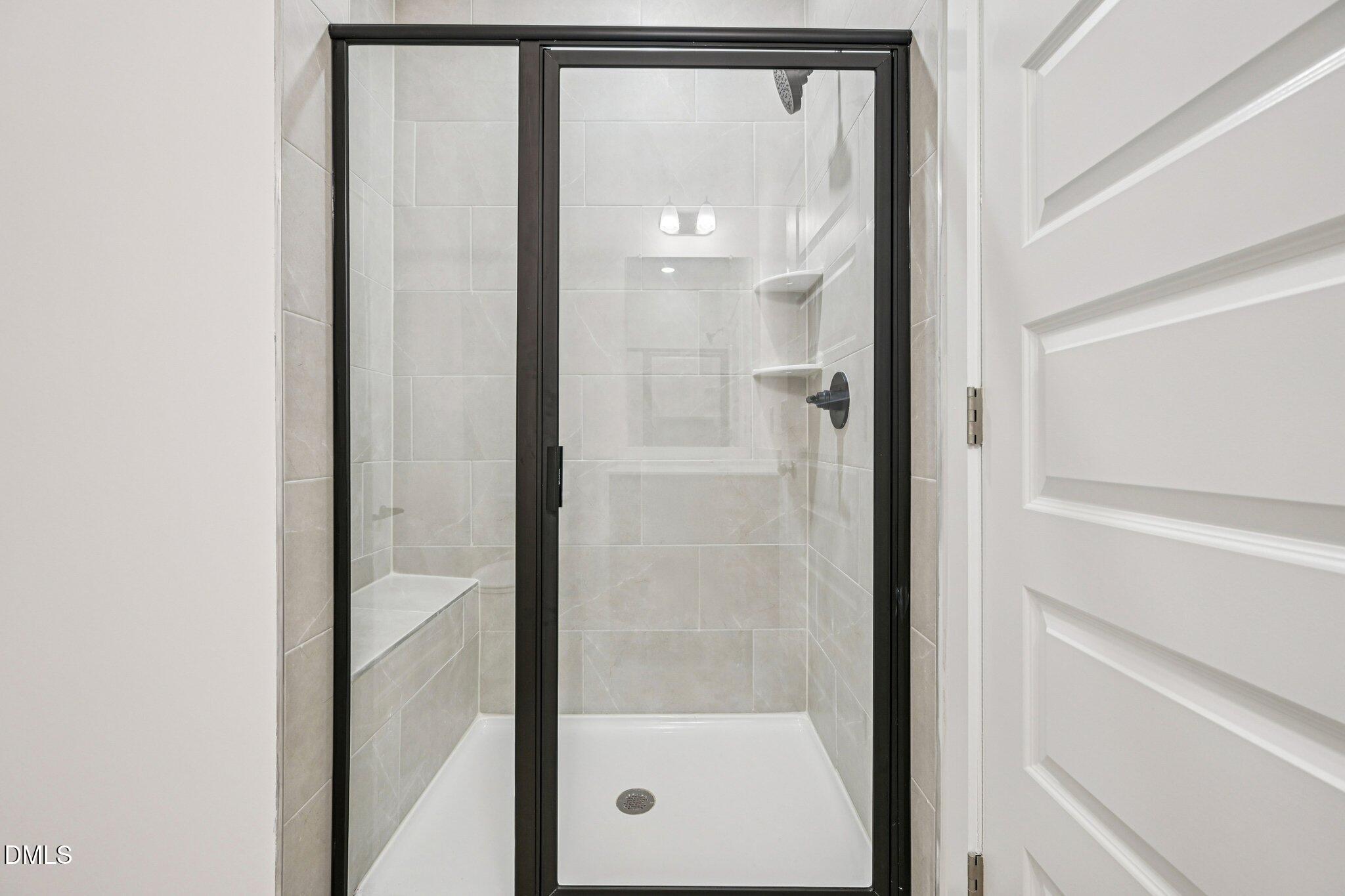 10905 Bayflower Way Raleigh, NC 27617 - Photo 29 of 49 a bathroom with a glass shower door