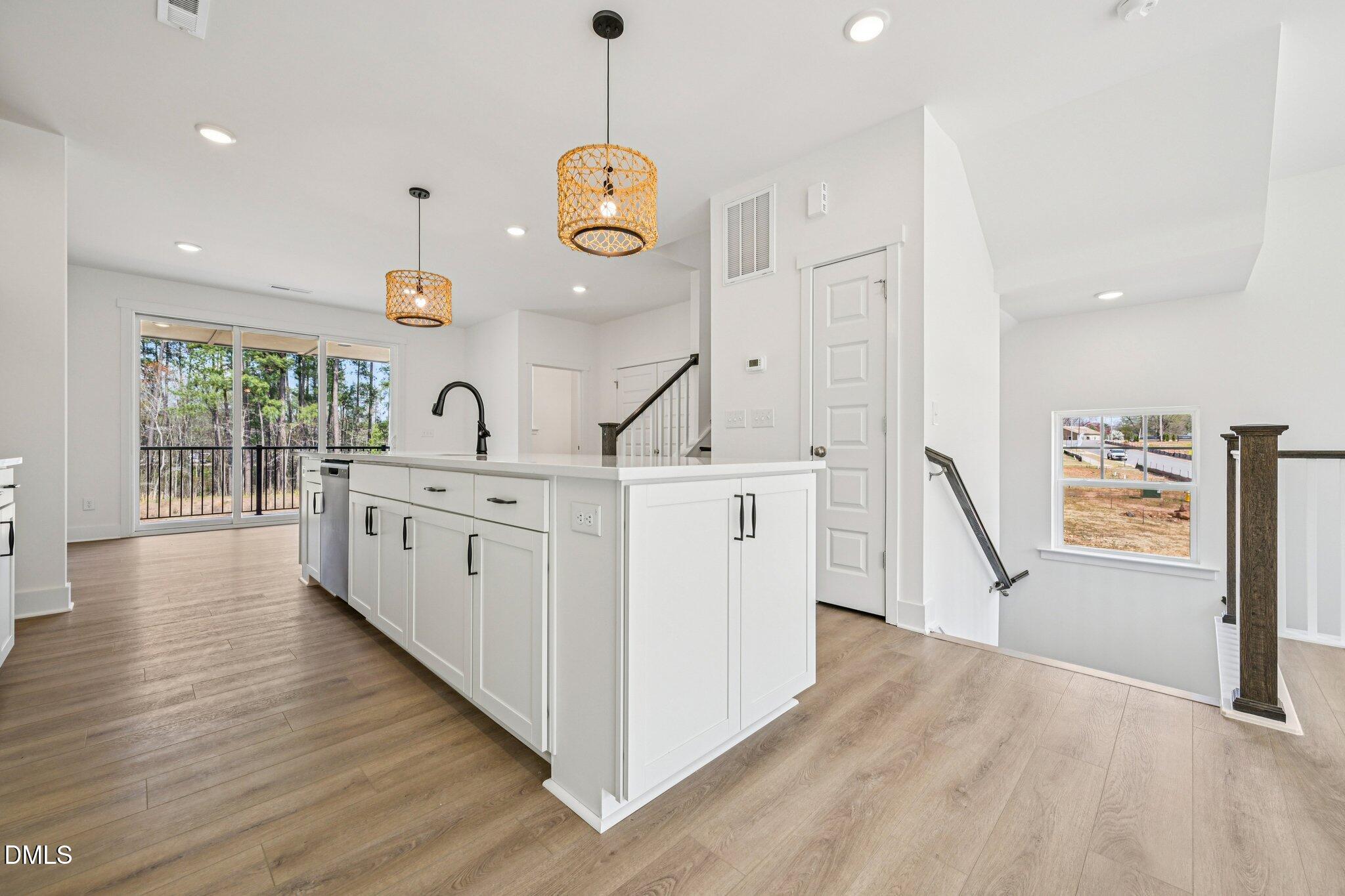 10905 Bayflower Way Raleigh, NC 27617 - Photo 7 of 49 a kitchen with counter top space and wooden floor