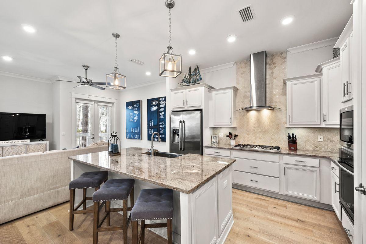 79 Pine Lands Loop Inlet Beach, Unit A Inlet Beach, FL 32461 - Photo 1 of 22 a large kitchen with granite countertop lots of counter space sink refrigerator and cabinets