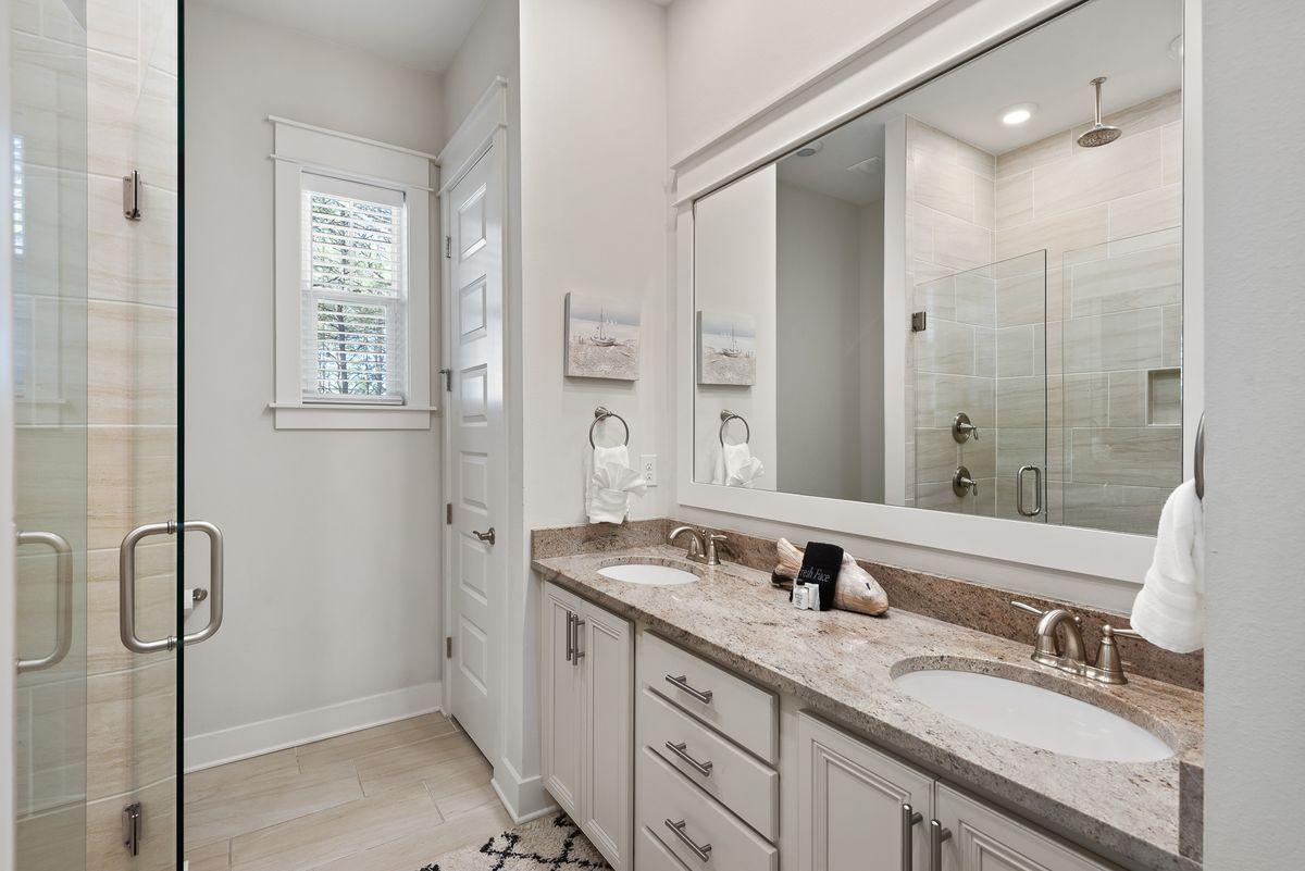 79 Pine Lands Loop Inlet Beach, Unit A Inlet Beach, FL 32461 - Photo 16 of 22 a bathroom with a granite countertop sink and a mirror