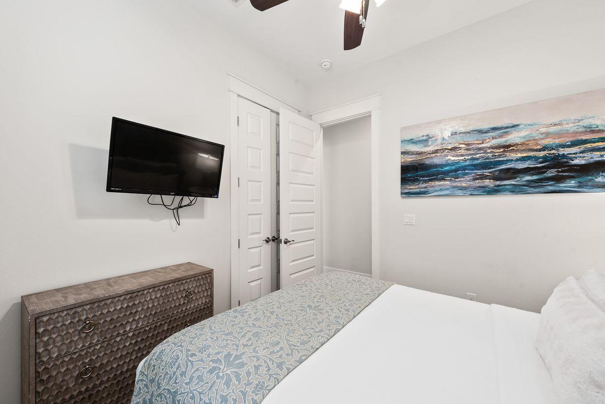 79 Pine Lands Loop Inlet Beach, Unit A Inlet Beach, FL 32461 - Photo 18 of 22 a bedroom with a bed and a flat screen tv