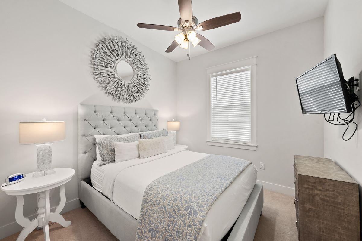 79 Pine Lands Loop Inlet Beach, Unit A Inlet Beach, FL 32461 - Photo 3 of 22 a bedroom with a bed and a lamp on the dresser