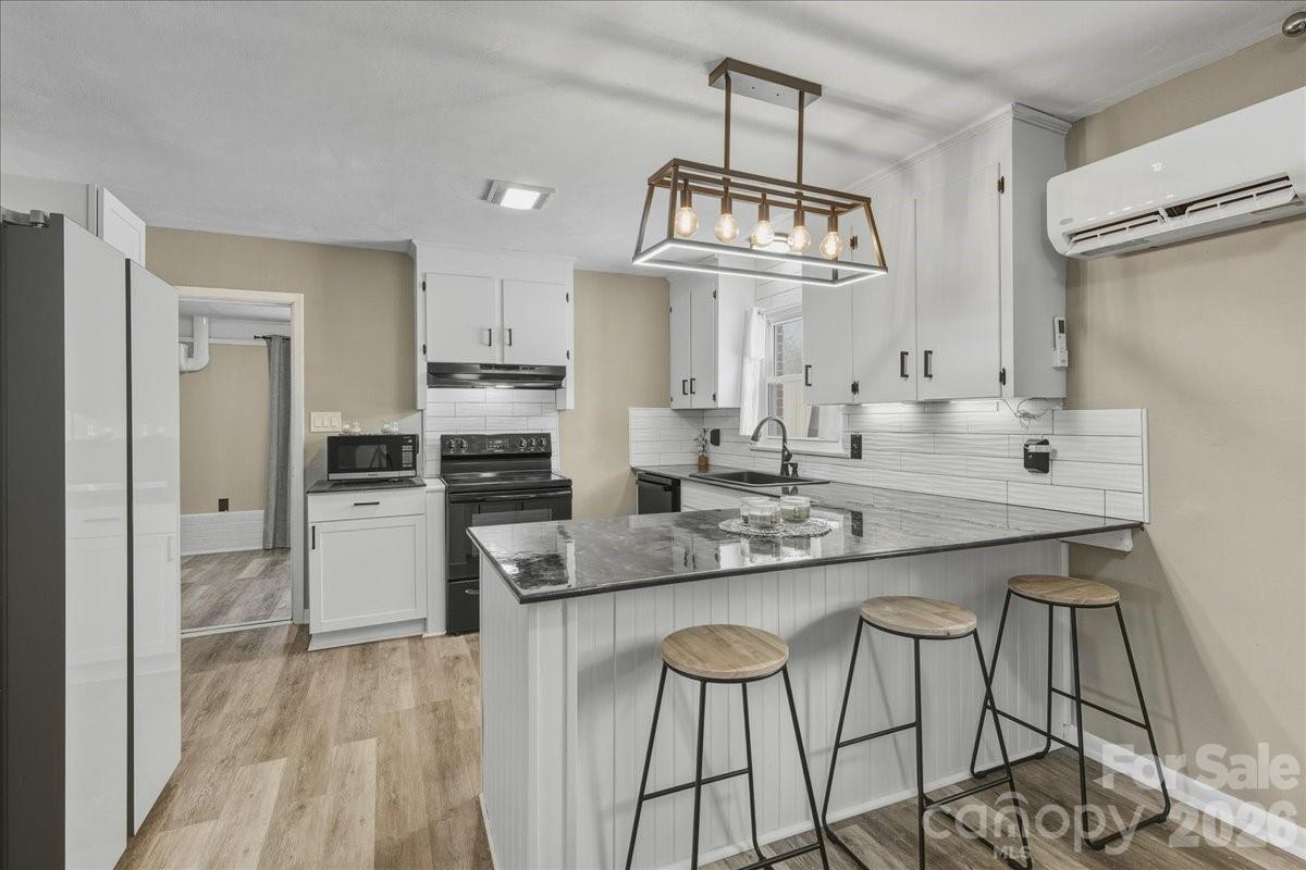 2563 Marble Street Newton, NC 28658 - Photo 16 of 40 a kitchen with stainless steel appliances granite countertop a sink and a refrigerator