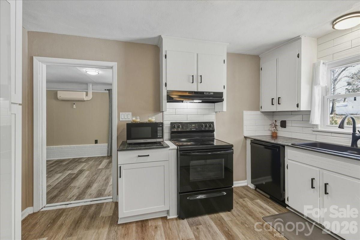 2563 Marble Street Newton, NC 28658 - Photo 17 of 40 a kitchen with white cabinets and appliances
