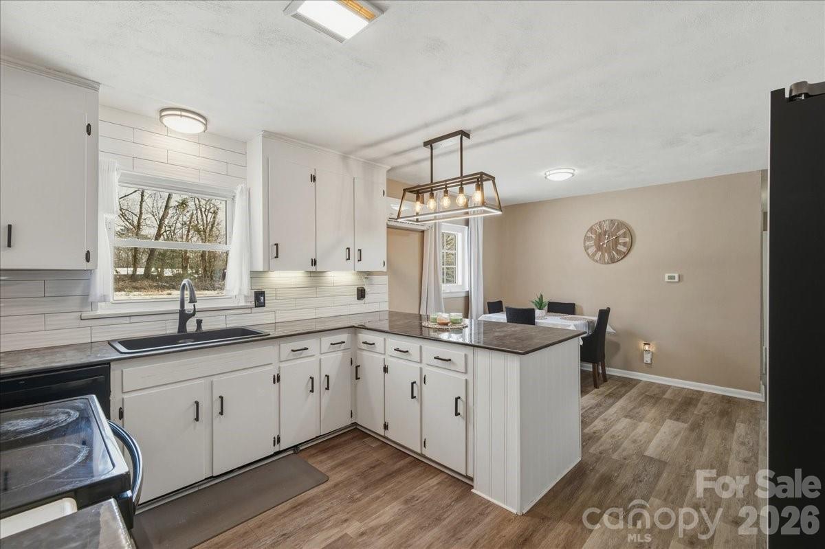 2563 Marble Street Newton, NC 28658 - Photo 19 of 40 a kitchen with stainless steel appliances granite countertop a sink and cabinets