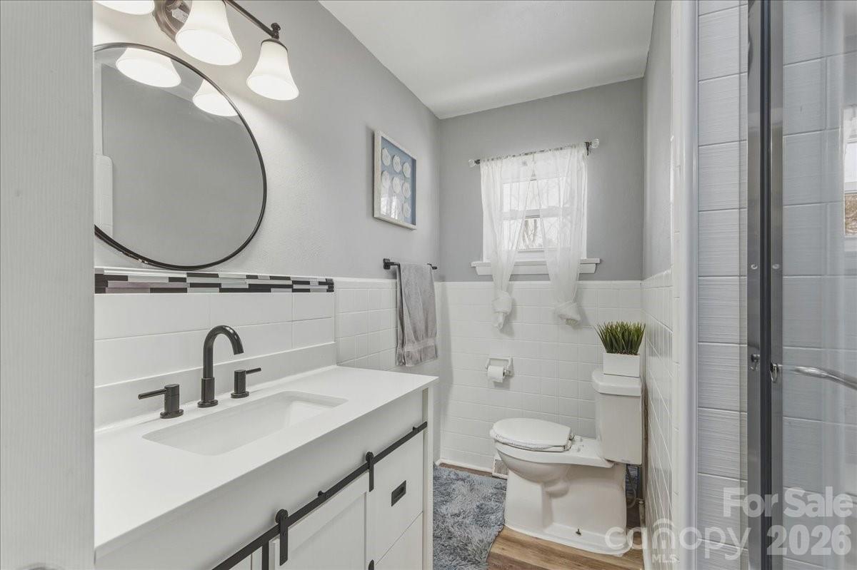 2563 Marble Street Newton, NC 28658 - Photo 27 of 40 a bathroom with a toilet a sink and mirror
