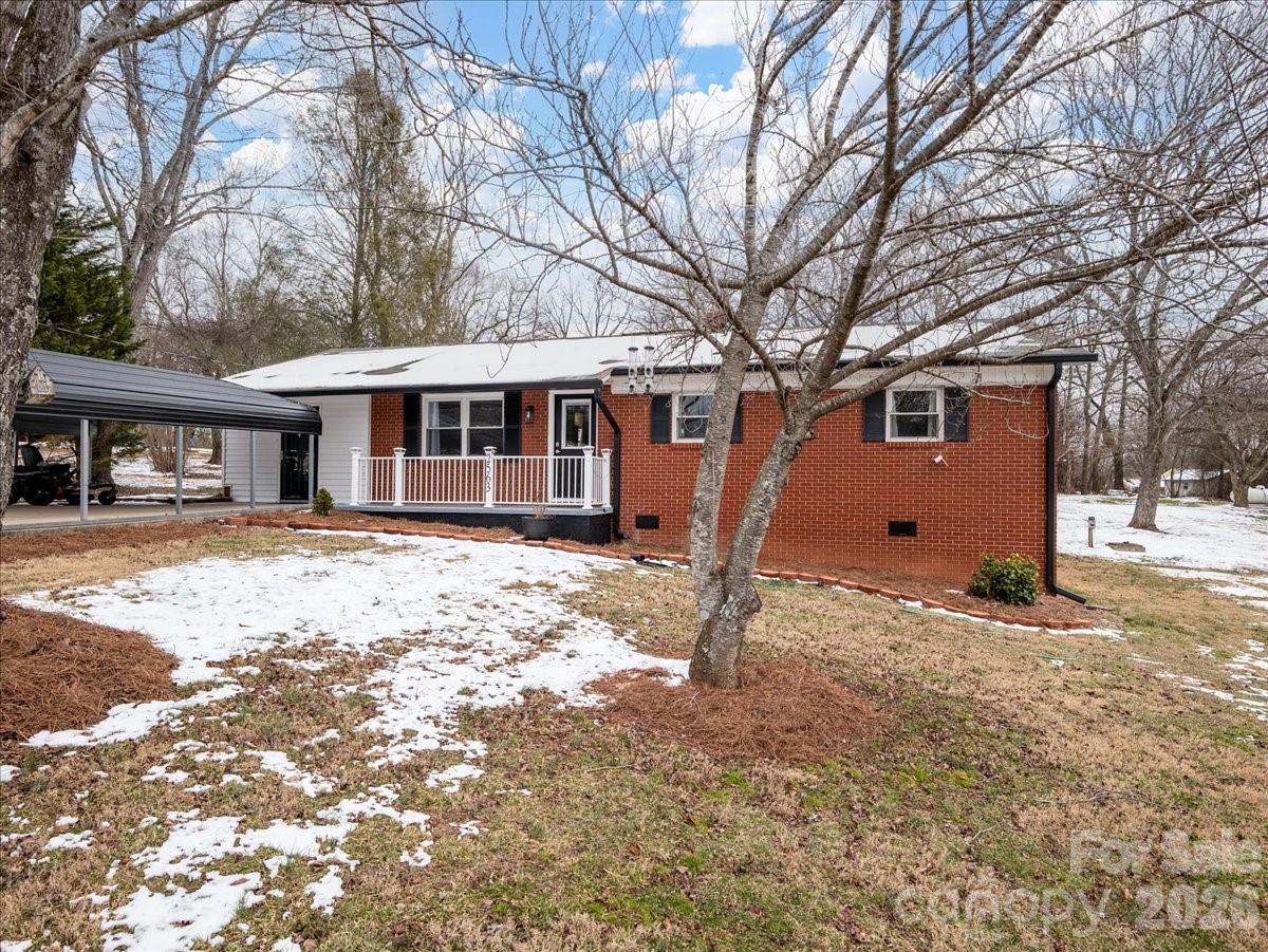2563 Marble Street Newton, NC 28658 - Photo 3 of 40 a front view of a house with a yard covered in snow