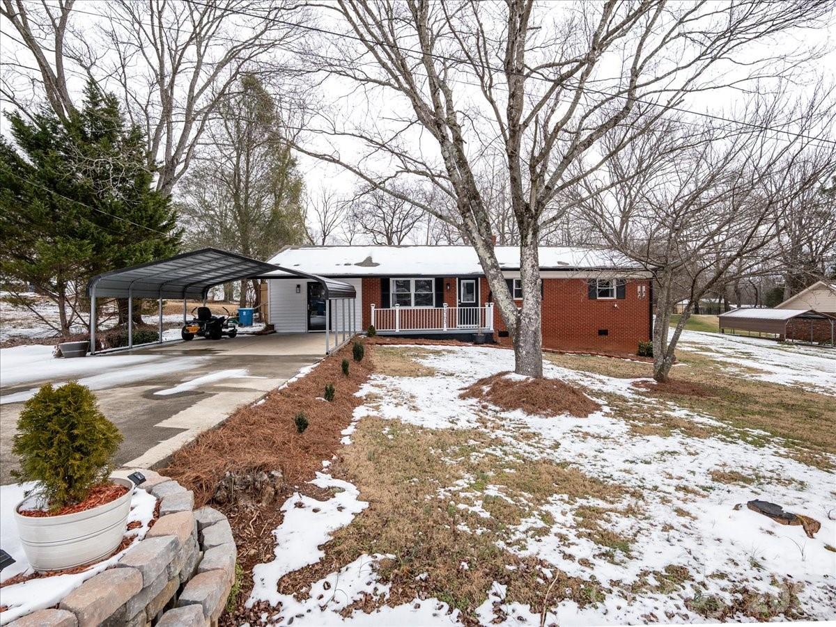 2563 Marble Street Newton, NC 28658 - Photo 4 of 40 a front view of a building with trees and covered with snow