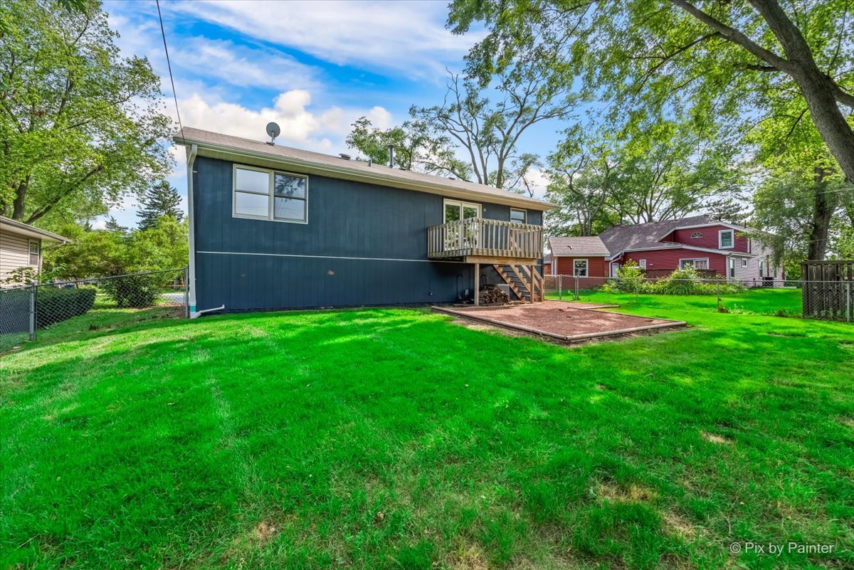 3 Deerpath Road Lake In The Hills, IL 60156 - Photo 25 of 27 a view of a backyard with table and chairs wooden fence