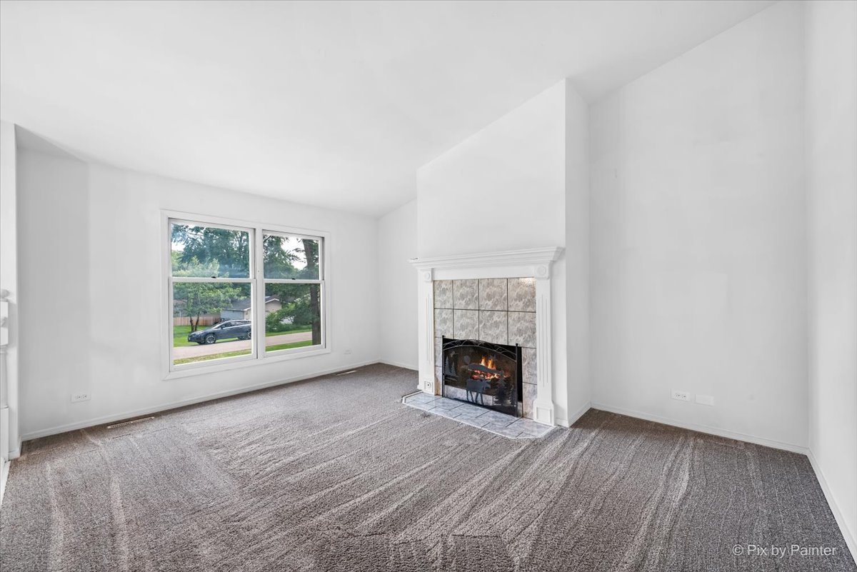 3 Deerpath Road Lake In The Hills, IL 60156 - Photo 3 of 27 a view of an empty room with a window and fireplace