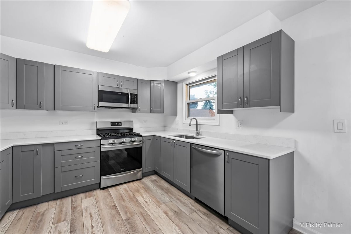 3 Deerpath Road Lake In The Hills, IL 60156 - Photo 6 of 27 a kitchen with sink a microwave and cabinets