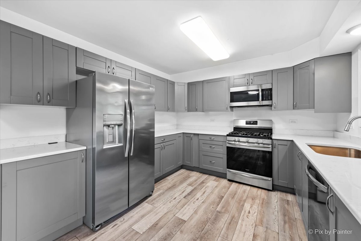 3 Deerpath Road Lake In The Hills, IL 60156 - Photo 8 of 27 a kitchen with a refrigerator stove and sink