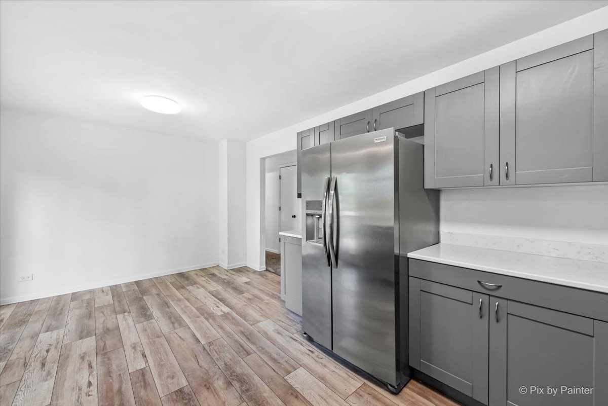 3 Deerpath Road Lake In The Hills, IL 60156 - Photo 9 of 27 a kitchen with a refrigerator a sink and cabinets