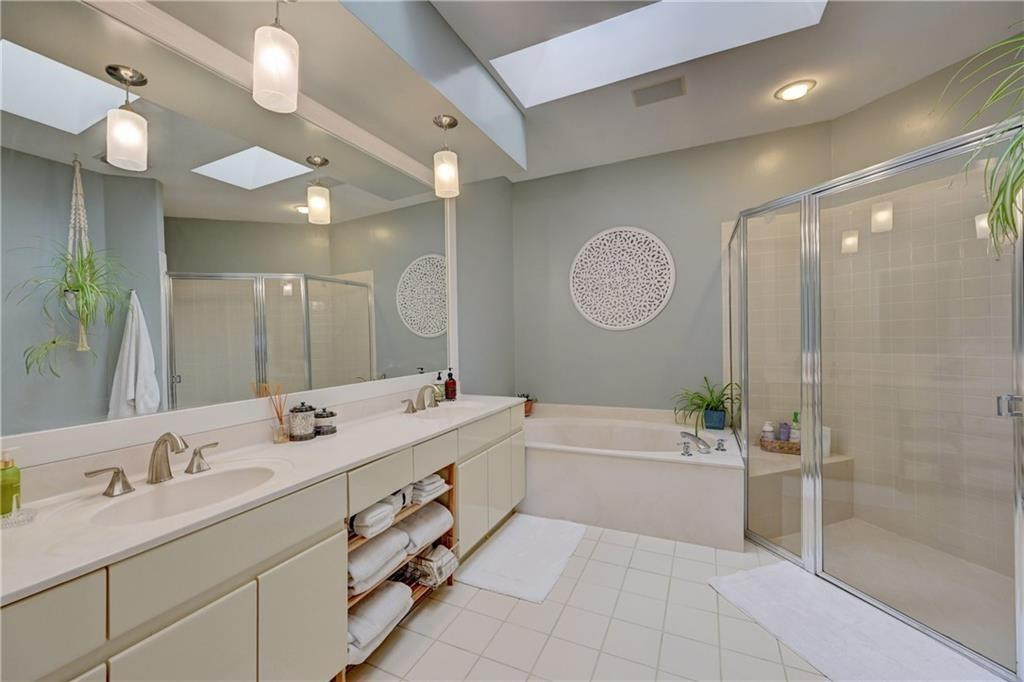 8171 Hampton Wood Drive Boca Raton, FL 33433 - Photo 18 of 56 a bathroom with a tub a sink double vanity and a mirror