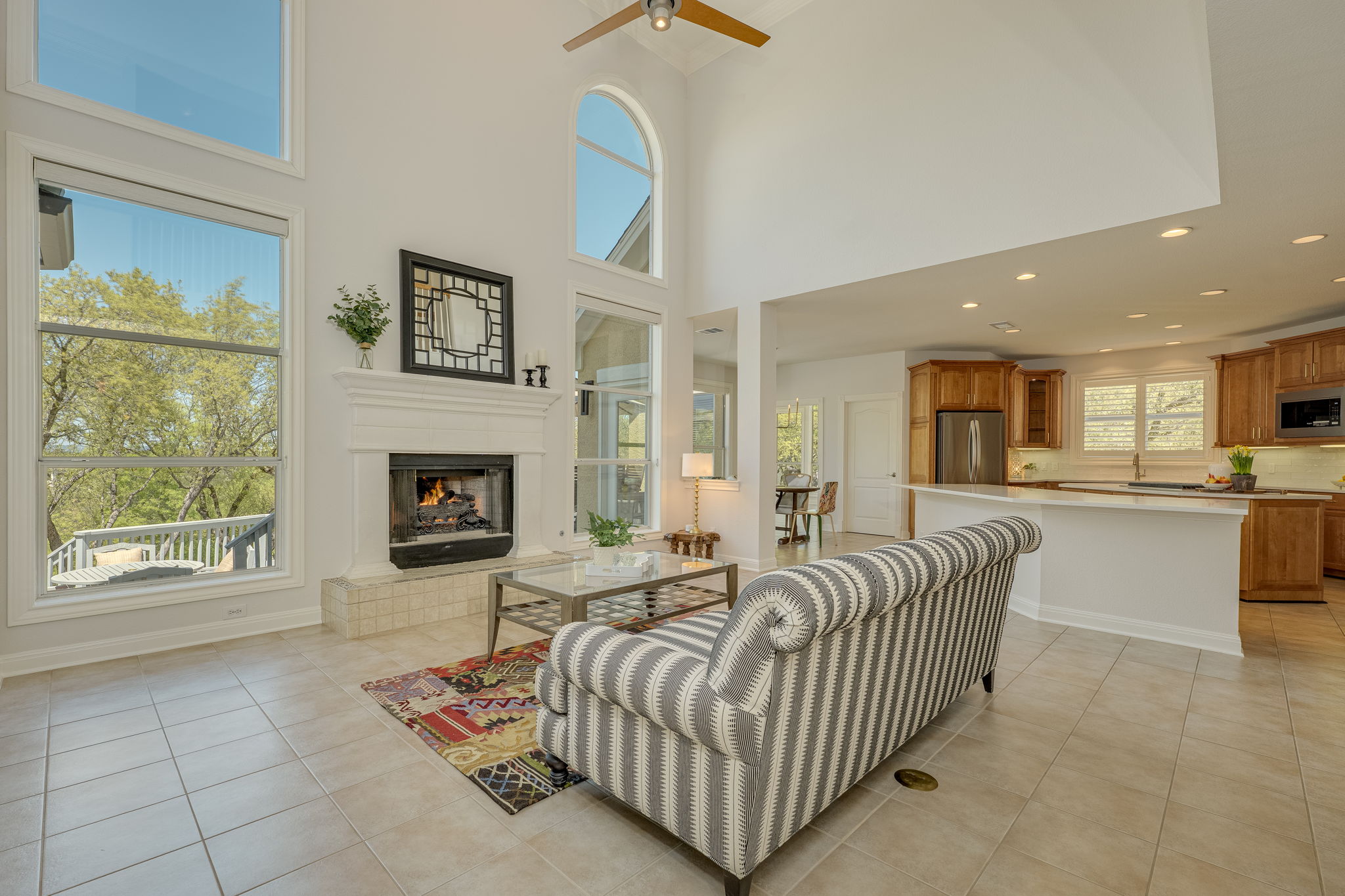 4424 Lago Viento Austin, TX 78734 - Photo 5 of 38 The family room is open to the kitchen and breakfast area and has soaring ceilings and tall windows to allow in the natural light and see the incredible view.