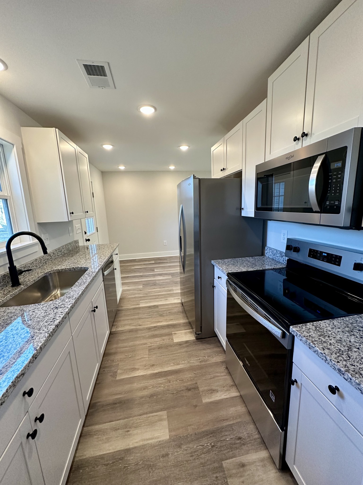 208 Derek Court Portland, TN 37148 - Photo 11 of 27 a large kitchen with stainless steel appliances wooden cabinets and granite counter tops