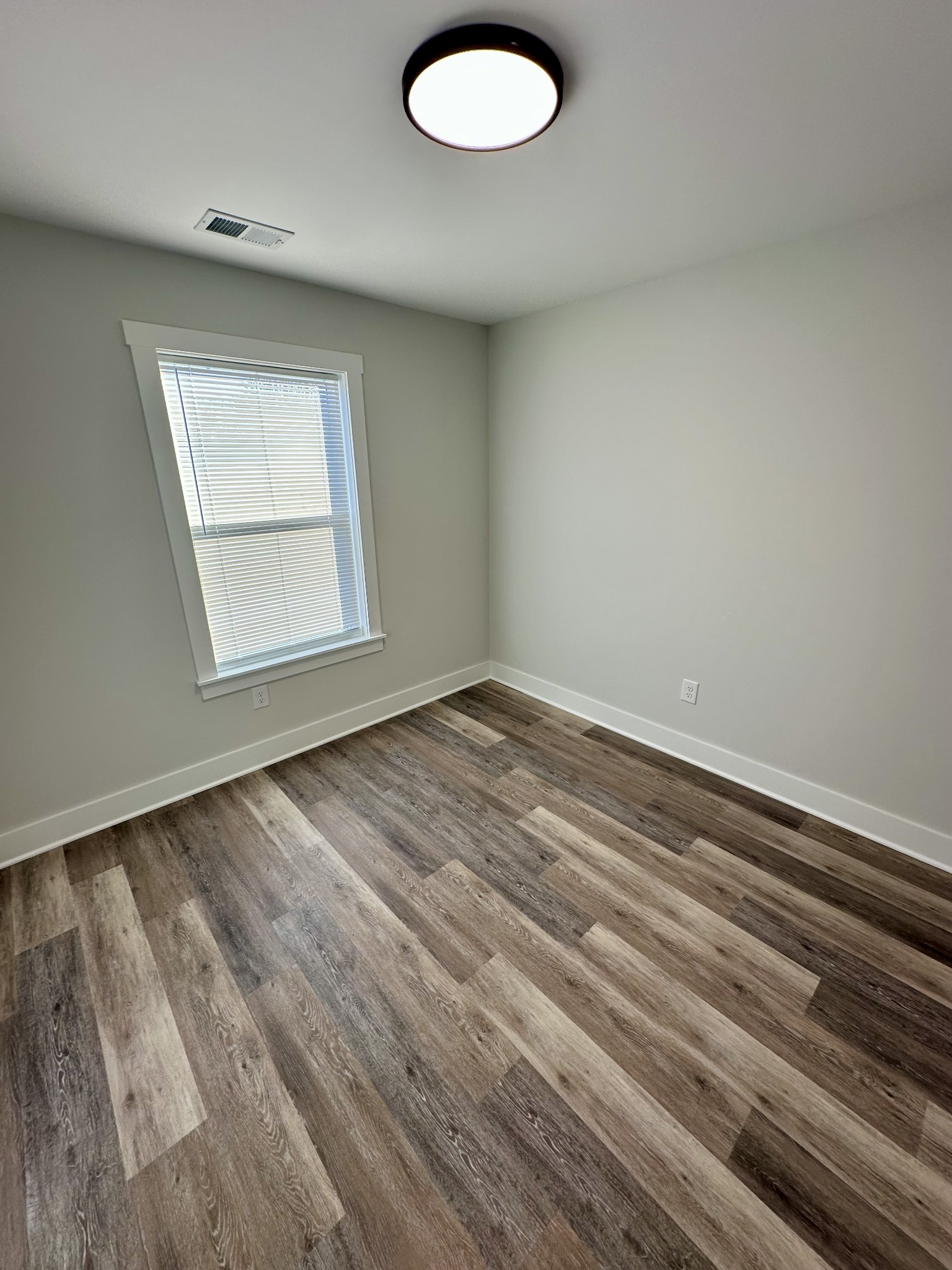 208 Derek Court Portland, TN 37148 - Photo 22 of 27 an empty room with wooden floor and windows