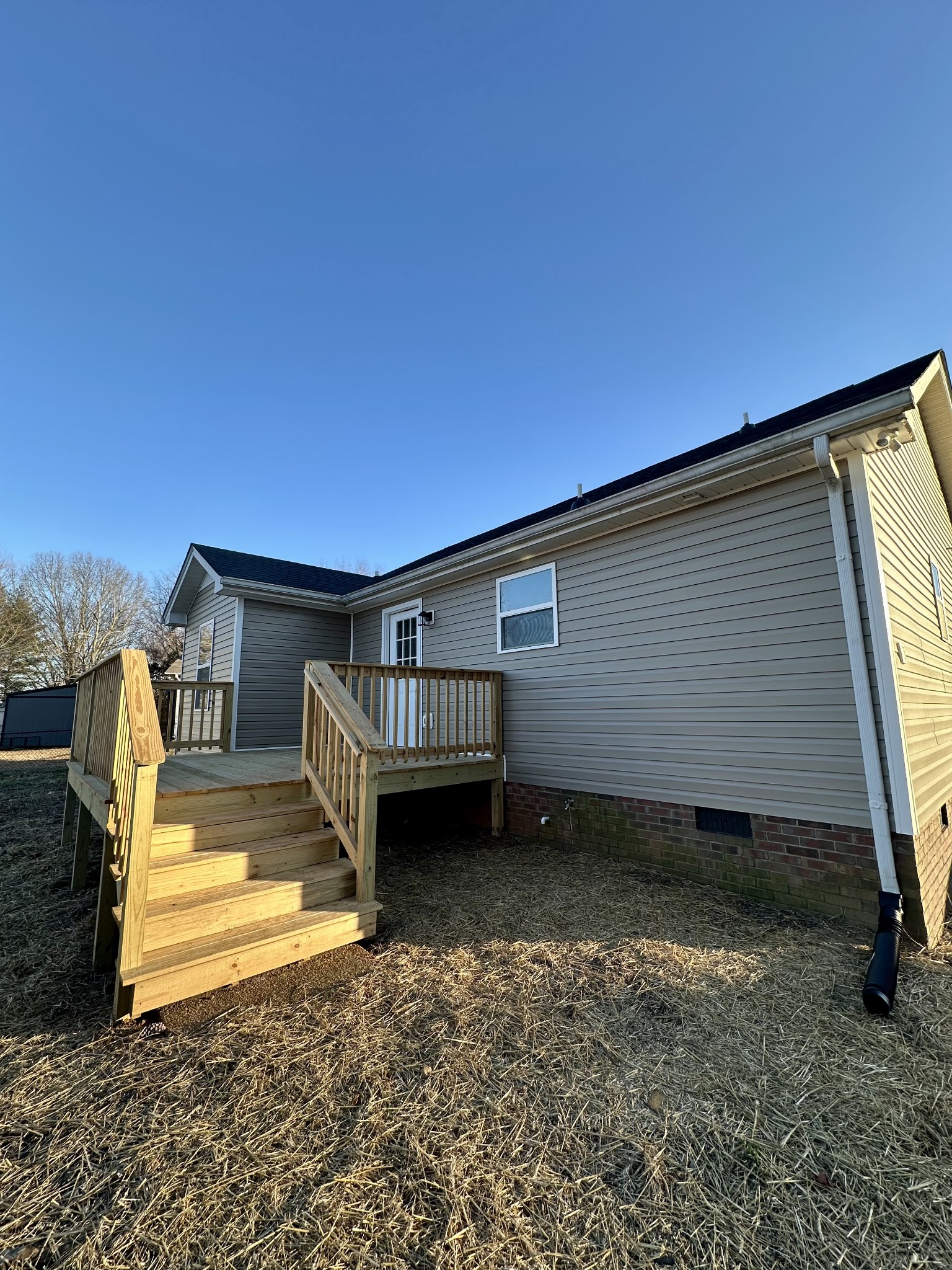 208 Derek Court Portland, TN 37148 - Photo 26 of 27 a view of a backyard with chairs and floor to ceiling window