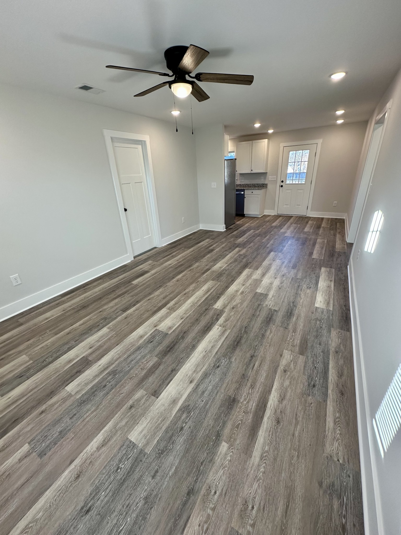 208 Derek Court Portland, TN 37148 - Photo 5 of 27 a view of a livingroom with a ceiling fan wooden floor and window