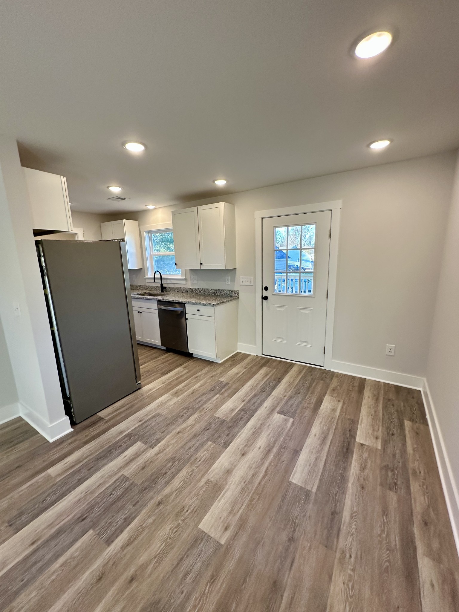 208 Derek Court Portland, TN 37148 - Photo 6 of 27 a open kitchen with kitchen island a sink dishwasher stove and refrigerator