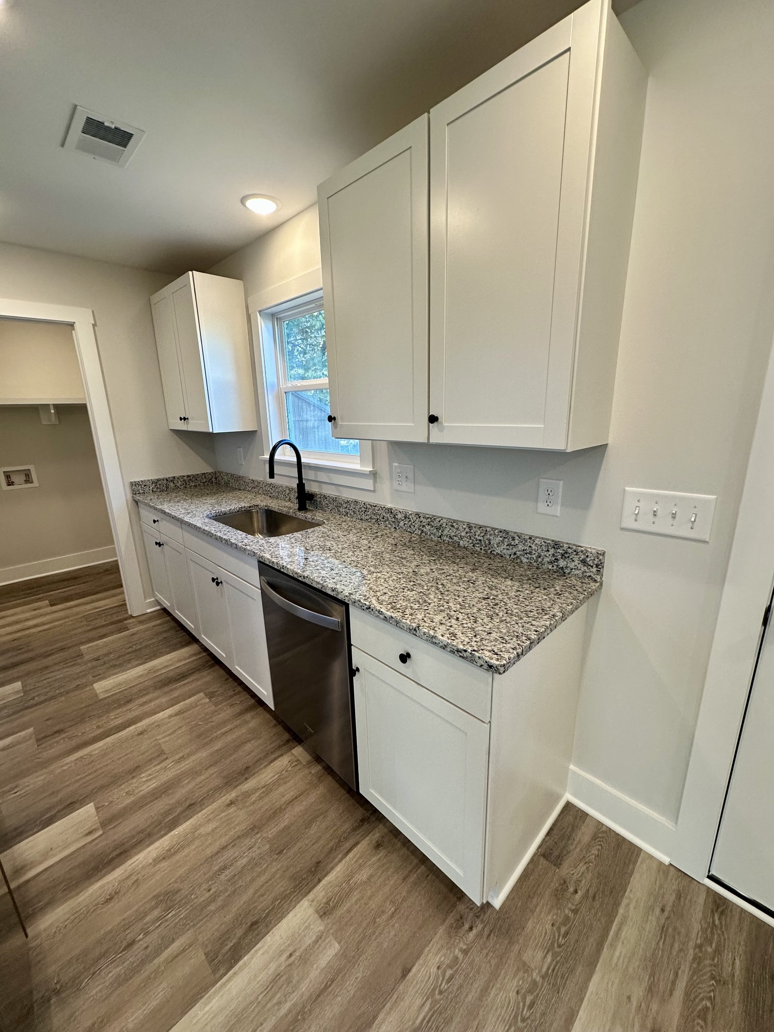 208 Derek Court Portland, TN 37148 - Photo 7 of 27 a kitchen with granite countertop a sink and cabinets