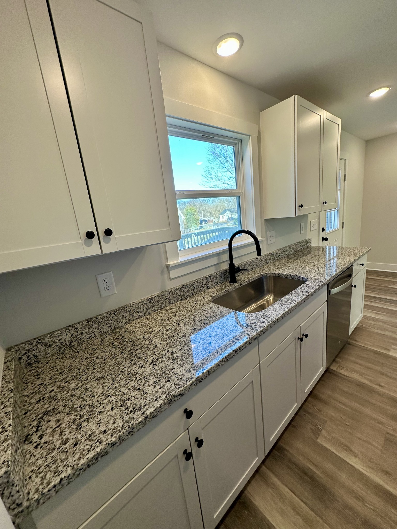 208 Derek Court Portland, TN 37148 - Photo 10 of 27 a kitchen with granite countertop a sink and a stove