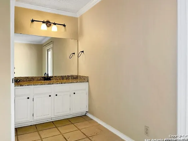 a bathroom with a granite countertop sink and a mirror